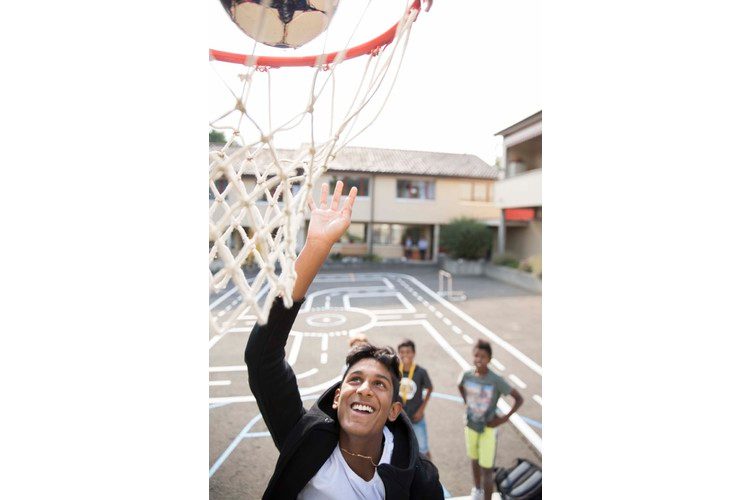 The boys in particular meet up after school on the home's basketball court.
