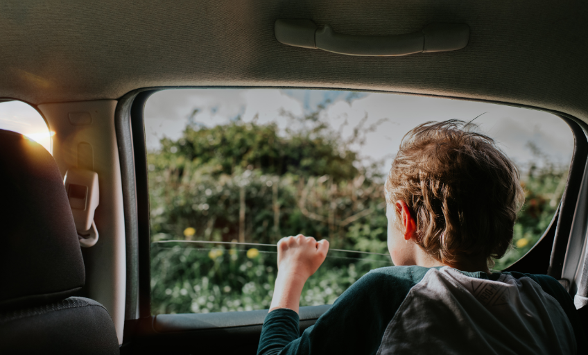Separation: A boy looks out of a car window
