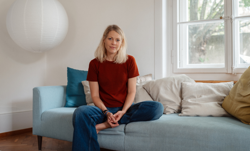 Jaël Malli on the sofa in her living room.