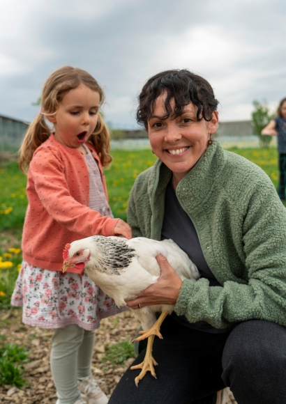 A mother and daughter with a chicken