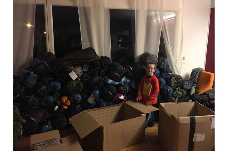 Fiona Kelly's sons are happy to help sort the donations in kind before their mum takes them to the refugee camps. Picture: Private