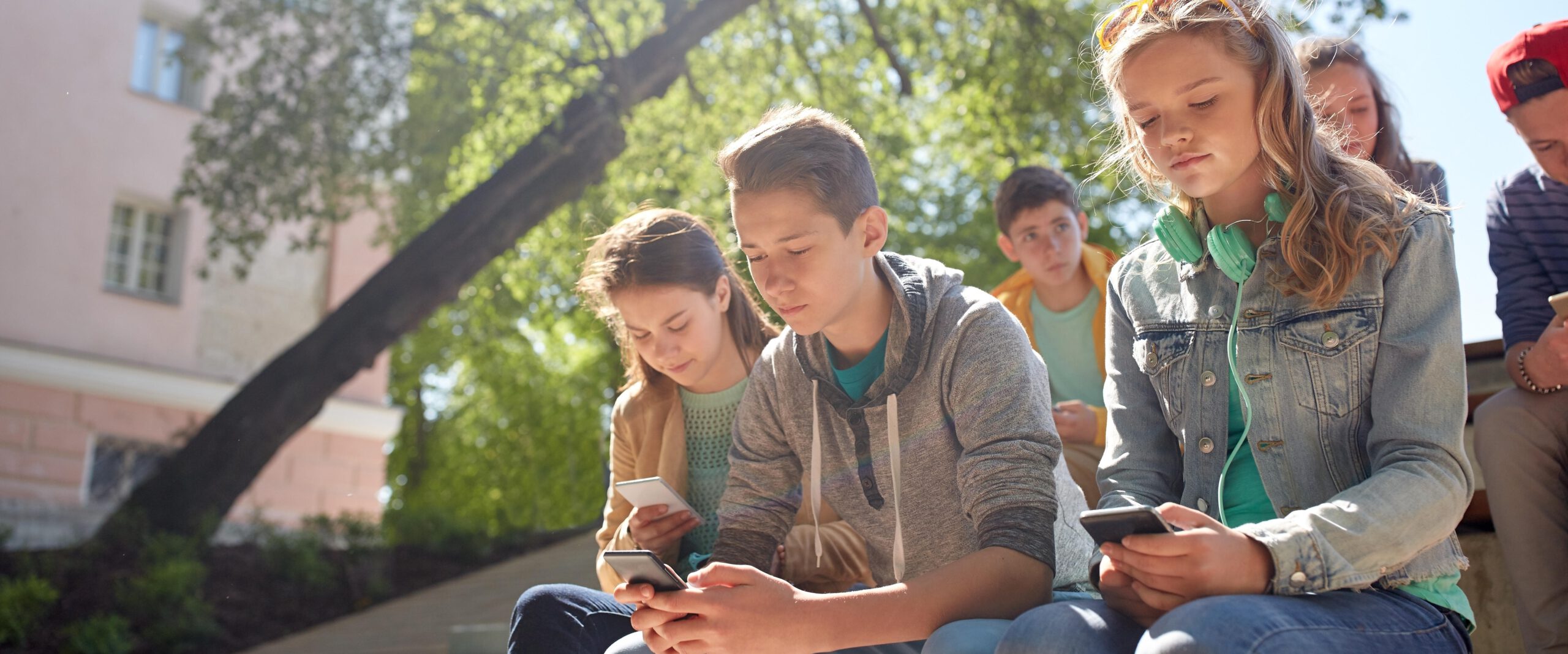 group of teenage friends with smartphones outdoors Herr Markowetz